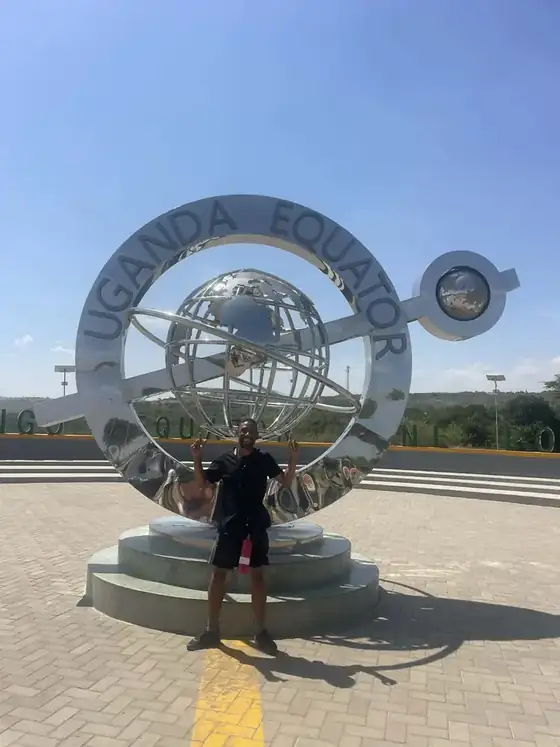 Leon in front of the steel Uganda Equator monument